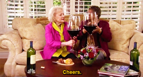 animated GIF of Betty White and friend clinking ridiculously enormous wine glases, with the caption 
