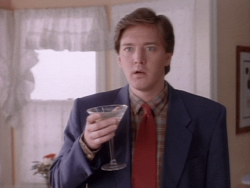 Animated GIF of a man in a suit dropping a martini glass in shock.