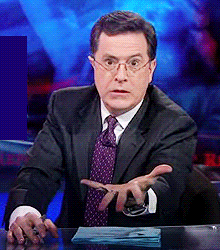 Looping animated GIF of Stephen Colbert holding out a hand and shouting "GIVE IT TO ME NOW".
